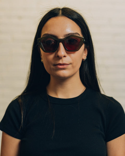 Front view of a woman wearing tortoise coloured oversized square sunglasses. And a side view with RBW inscribed in white. 