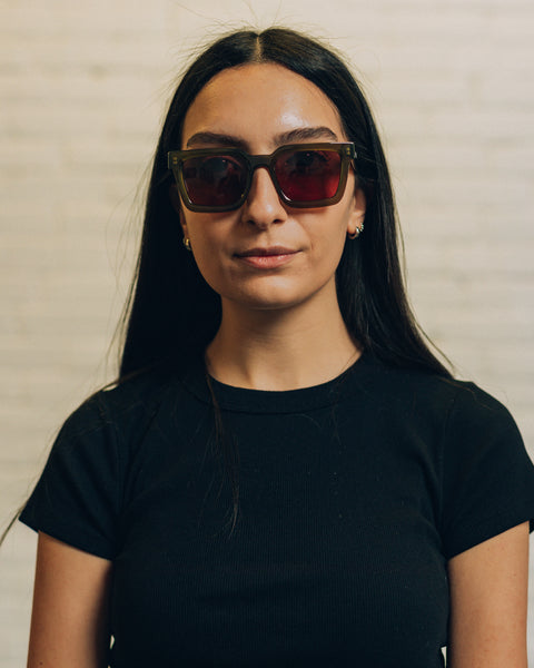 Front view of a woman wearing tortise coloured geometric sunglasses. And a side view with RBW inscribed in white. 