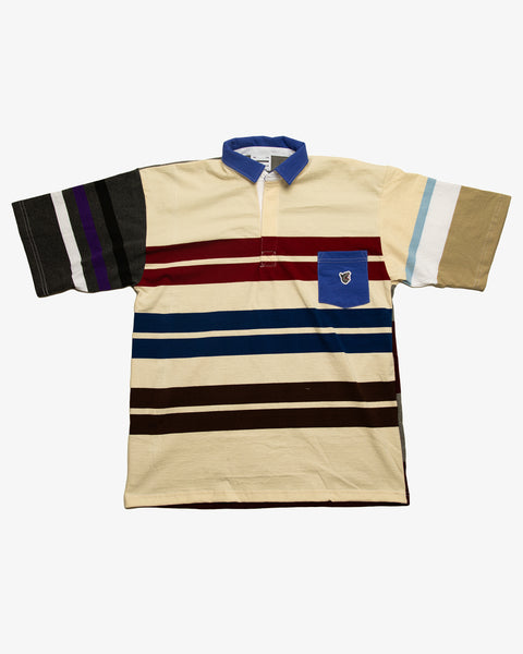 Navy striped patchwork rugby t-shirt with multi-coloured striped sleeves and a dark green pocket featuring the RBW wolf logo.