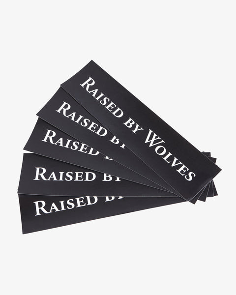 Five black Raised By Wolves logo stickers.