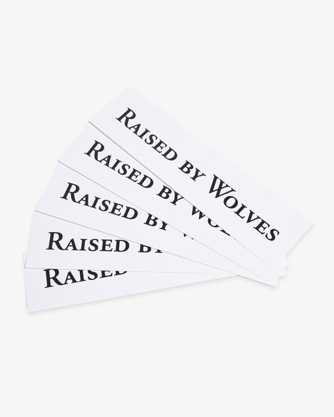 Five white Raised By Wolves logo stickers.