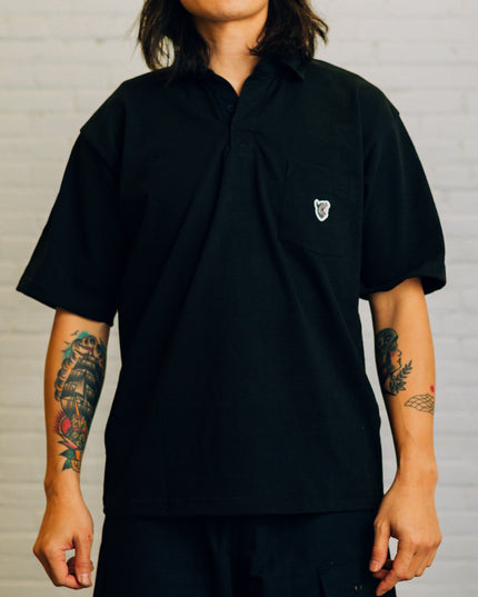 Font view of a black rugby t-shirt featuring the Raised By Wolves wolf logo.