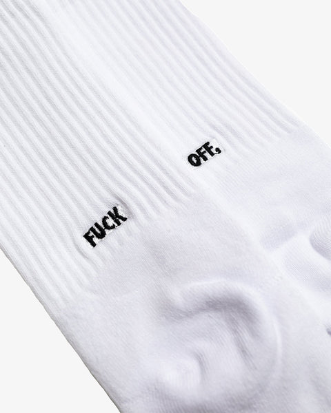 The back view of a raindow dyed pair of socks with “FUCK OFF” embroidered in black.