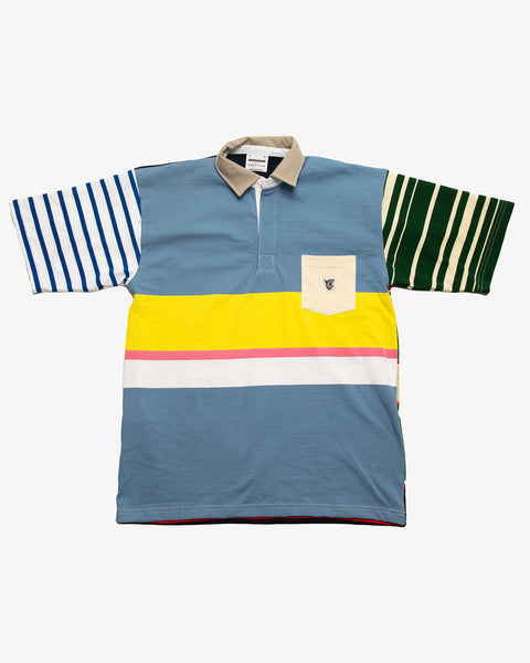 Cream striped patchwork rugby t-shirt with multi-coloured striped sleeves and a blue pocket featuring the RBW wolf logo. 